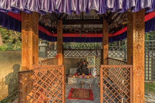 an entrance to a temple with a purple and red curtain at Hotel Riverside with Swimming pool in Sauraha