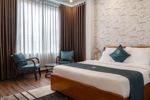 a hotel room with a bed and two chairs at Hanoi Bliss Mai Hac De in Hanoi