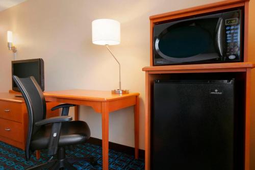 a room with a desk and a microwave and a table at Fairfield Inn & Suites Longview in Longview