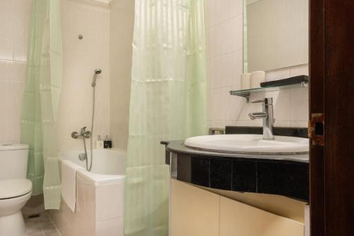 a bathroom with a sink and a toilet and a shower at Hanoi Bliss Mai Hac De in Hanoi