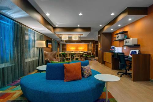 a living room with a blue couch and a table at Fairfield Inn & Suites by Marriott Fort Worth I-30 West Near NAS JRB in Fort Worth