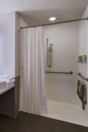 a shower with a white shower curtain in a bathroom at Element Houston Vintage Park in Houston