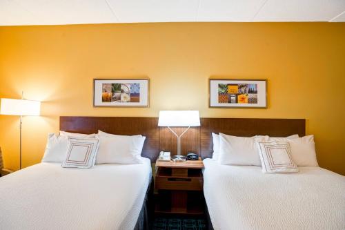two beds sitting next to each other in a hotel room at Fairfield Inn & Suites Christiansburg in Christiansburg