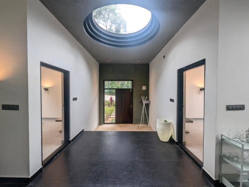 a large room with a large skylight in the ceiling at Birdsong Luxury Pool Villa by Luxunlock Private Villas in Suntikoppa