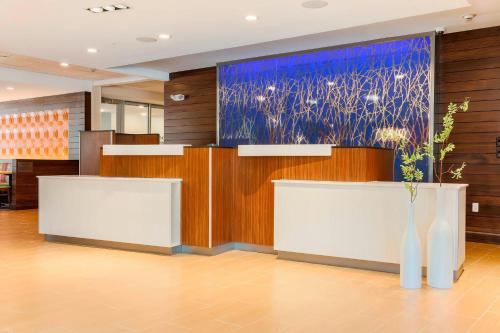 a lobby with a large painting on the wall at Fairfield Inn & Suites by Marriott Decatur at Decatur Conference Center in Decatur