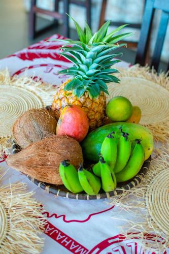 a plate of tropical fruits on a table at Ô Bleu Azur in Antsatrakolo