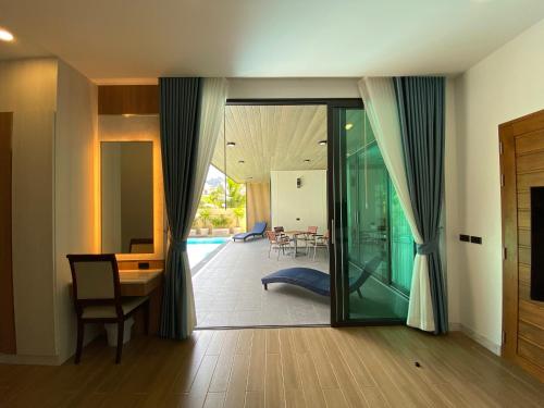 a living room with a desk and a dining room at Villa Nadsuree Ao-Nang Luxury Modern House in Ao Nang 