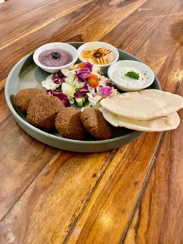 a tray of food on a table with a plate of food at Marine Ganga Stays in Rishīkesh