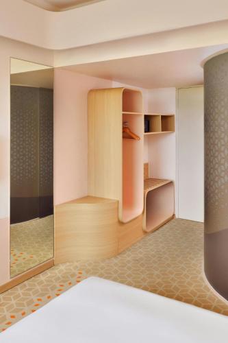 a room with a wardrobe and a mirror at Fairfield by Marriott Chennai Mahindra World City in Chengalpattu