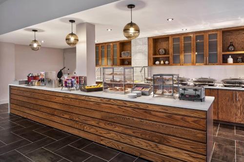 a kitchen with a large wooden counter top at Delta Hotels by Marriott Norfolk Airport in Norfolk