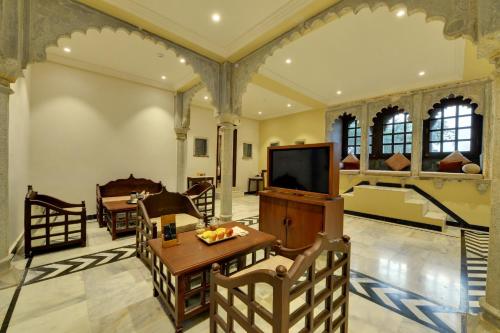 a living room with a television and a table at The Fern Bambora Fort, Bambora, Udaipur in Udaipur