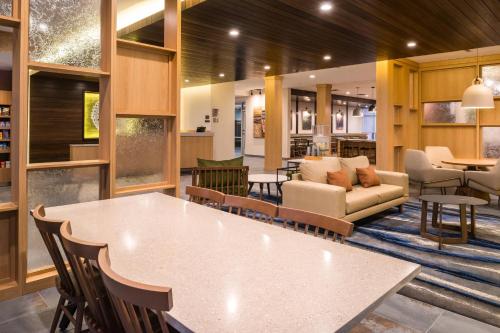 a lobby with a large white table and chairs at Fairfield Inn & Suites by Marriott Fort Worth Southwest at Cityview in Fort Worth