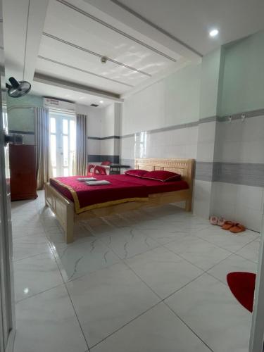 Khách Sạn Kim Thanh في مدينة هوشي منه: غرفة نوم مع سرير مع لحاف احمر