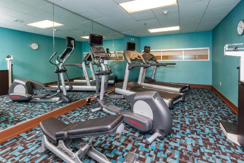 a gym with several tread machines in a room at Fairfield Inn & Suites Des Moines West in West Des Moines