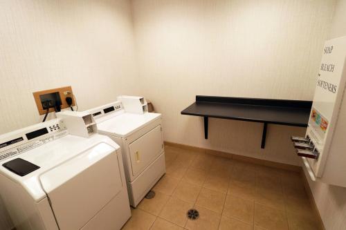 a kitchen with a washer and dryer in a room at Fairfield Inn & Suites Des Moines Airport in Des Moines