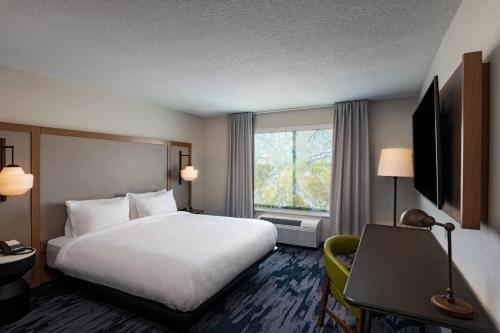 a hotel room with a bed and a window at Fairfield Inn & Suites by Marriott Oskaloosa in Oskaloosa