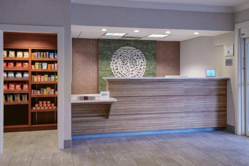 a pharmacy lobby with a counter and a book shelf at Fairfield Inn & Suites Detroit Livonia in Livonia