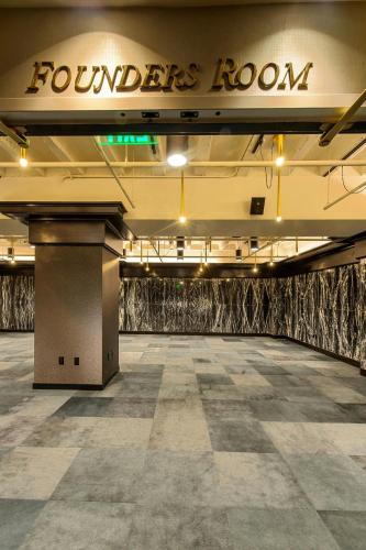 a large room with a floor with a sign on it at WATERMARK Baton Rouge, Autograph Collection in Baton Rouge