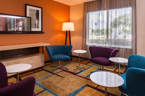a waiting room with chairs and tables and a window at Fairfield Inn and Suites by Marriott San Antonio Northeast / Schertz / RAFB in Schertz