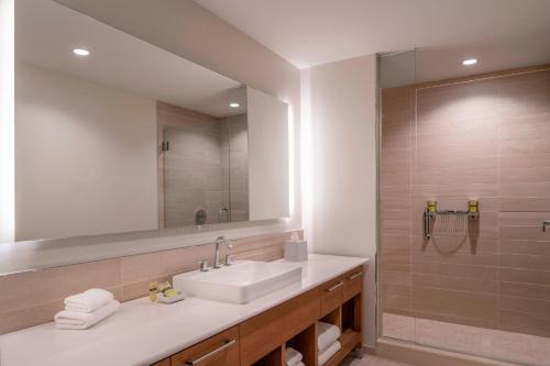 a bathroom with a sink and a large mirror at Element Fort Lauderdale Downtown in Fort Lauderdale