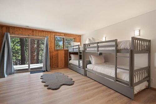 a bedroom with two bunk beds and a window at Pine Knoll in Bend