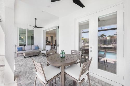 a dining room with a table and chairs at 2024 Monsterrat model waterfront home with lap pool in Marco Island