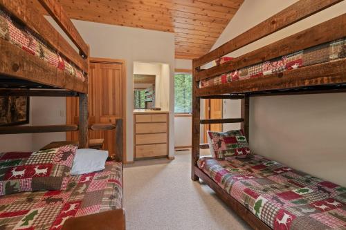a bedroom with two bunk beds and a bathroom at Glaze Meadow 376 in Black Butte Ranch