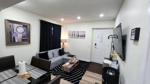 a living room with a couch and a table at Charming Oasis Tranquil Suite 8 min Airport, AC in Calgary