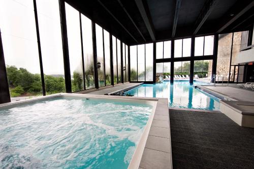 a large swimming pool in a building with windows at Lodge of Four Seasons Golf Resort, Marina & Spa in Lake Ozark