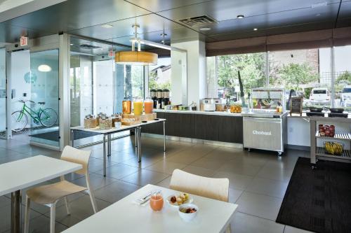 a restaurant with white tables and chairs and a counter at Element Las Vegas Summerlin in Las Vegas