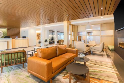 a living room with a couch and a table at Fairfield by Marriott Inn & Suites Cape Coral North Fort Myers in Cape Coral