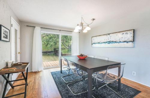 a dining room with a table and chairs and a window at Point Lyle in Mosier