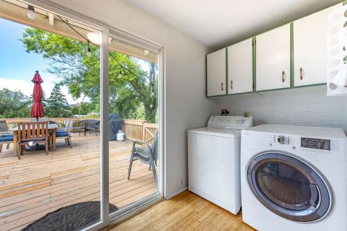 a washer and dryer in a laundry room with a deck at Point Lyle in Mosier