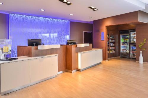 a lobby of a store with a counter and a pharmacy at Fairfield Inn & Suites by Marriott Warrensburg in Warrensburg