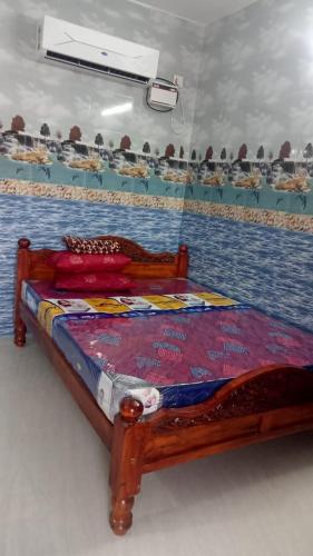 Ένα ή περισσότερα κρεβάτια σε δωμάτιο στο Sri Vasavi Home Stay