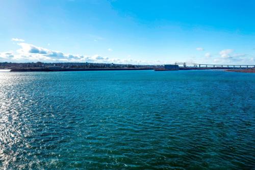 a large body of water with a bridge in the background at Delta Hotels by Marriott Sault Ste. Marie Waterfront in Sault Ste. Marie
