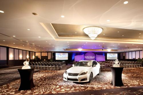 a white car parked in a room with chairs at Delta Hotels by Marriott Edmonton South Conference Centre in Edmonton