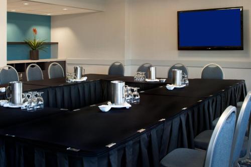 a conference room with tables and chairs and a flat screen tv at Delta Hotels by Marriott Edmonton South Conference Centre in Edmonton