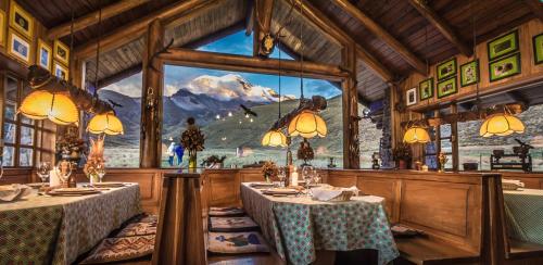 a restaurant with two tables and a large window at Chimborazo Lodge in Chimborazo