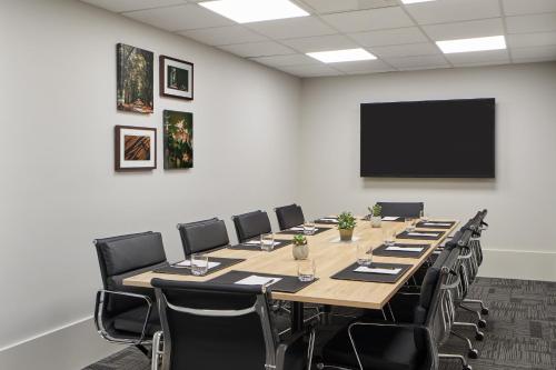 a conference room with a long table and chairs at Element Melbourne Richmond in Melbourne