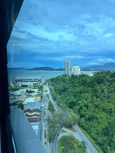 a view of a city from a window of a train at JQ1 SEA & POOL or CITY View WIFI I WASHING MACHINE for Some Units I CUCKOO WATER Jesselton Quay by R2 in Kota Kinabalu