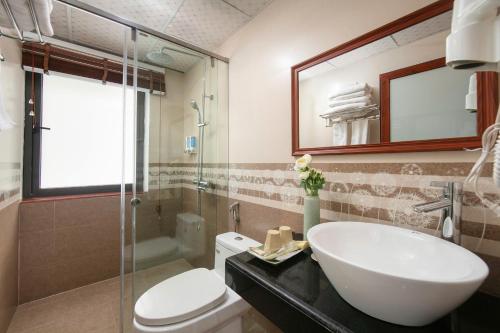 a bathroom with a sink and a toilet and a mirror at Sapa Mountain Queen House in Sapa