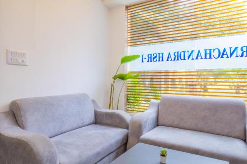 a living room with two chairs and a table at Housr HSR 1 Studio Apartment Near Manipal Hospital in Bengaluru