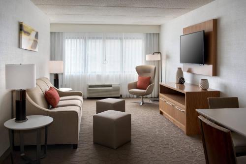 a large hotel room with a living room at Delta Hotels by Marriott Utica in Utica