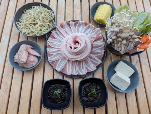 a group of bowls of food on a wooden table at 8POINT RESORT Okinawa in Nanjo