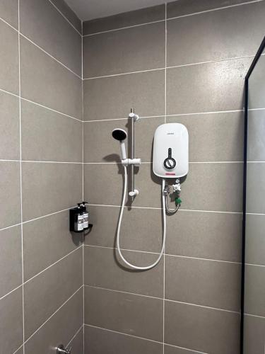 a shower in a bathroom with a hose at Hotel Ivory Papar in Papar