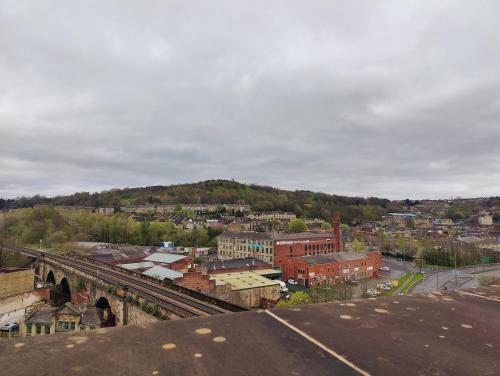 an aerial view of a city with a mountain at PENTHOUSE APARTMENT - FREE GARAGED Parking - BALCONY - GYM in Dewsbury