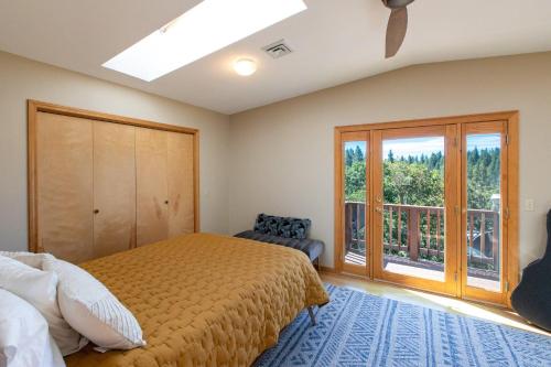 a bedroom with a bed and a large window at The Oaks in Lyle
