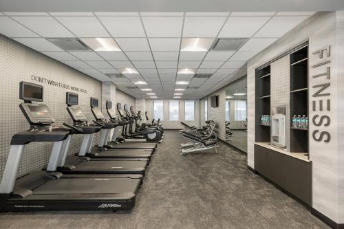 a gym with a row of treadmills and machines at Fairfield Inn & Suites by Marriott Des Moines Downtown in Des Moines