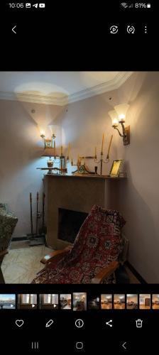 a living room with a bed and a fireplace at Lenges House in Vagramaberd